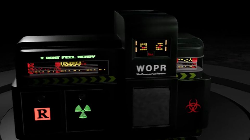 A lime-green 'Revenge' box on a turntable reveals itself as a black WOPR-style console with neon displays.