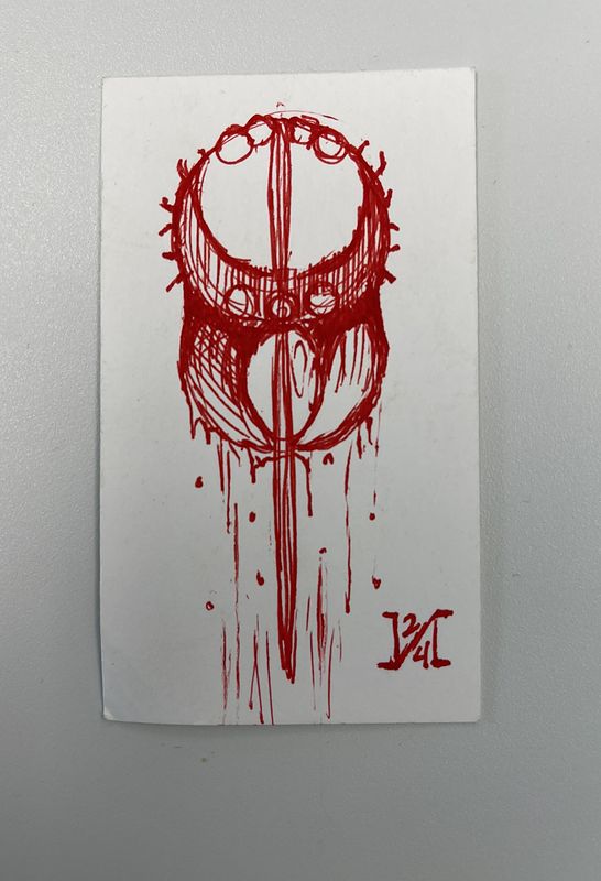 Red ink drawing on a white card of an ornate circular sigil split by a vertical blade, with paint dripping down from it and a monogram signature at the bottom right.