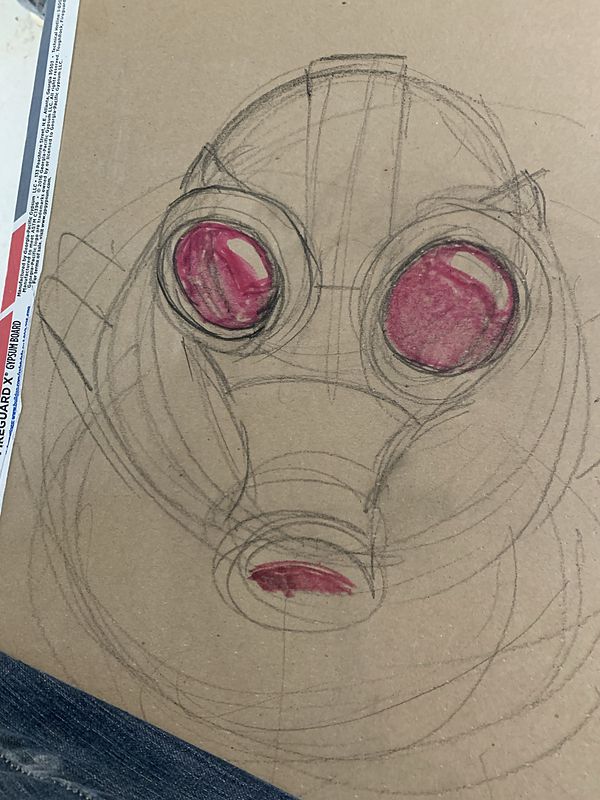 Pencil construction sketch on paper of a gas-mask face, with large round eye lenses and the mouth filter shaded in pink.