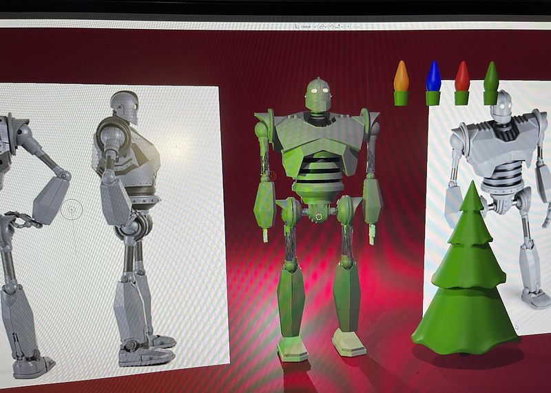 3D models of a tall retro giant robot shown in grey and green shaded versions beside a green cone-shaped tree and colored lightbulbs, against a red backdrop.